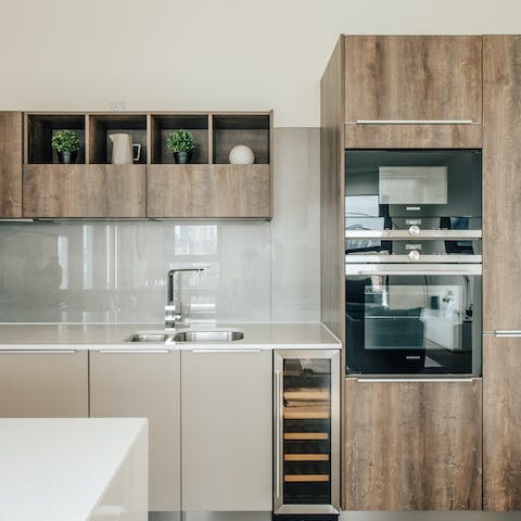 Cook up some bangers and mash for dinner in the sleek kitchen