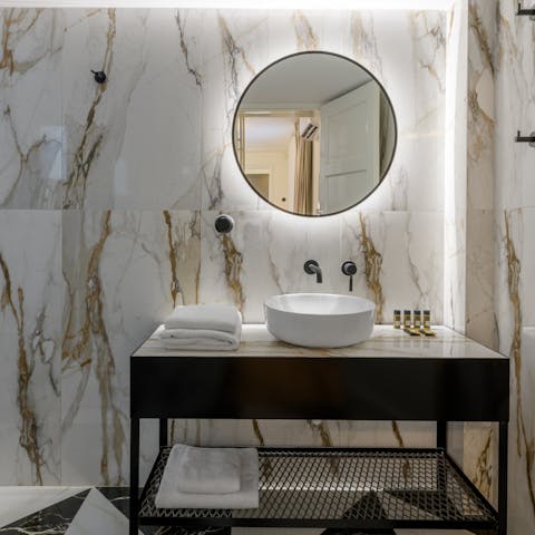 Get ready in the marble-clad bathroom for a night out in Athens