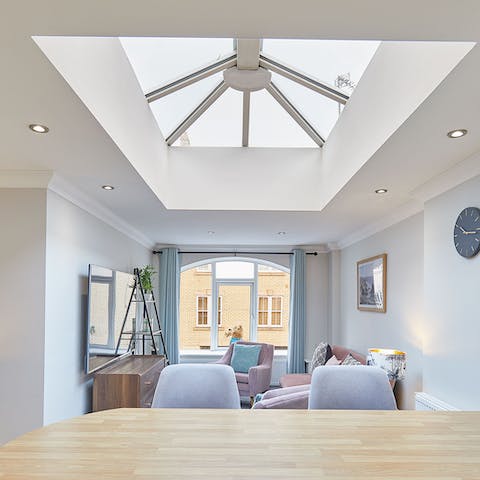 Relax in the bright living space, beneath the huge roof lantern