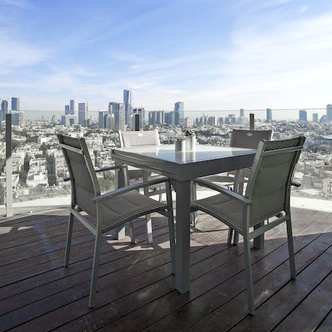 Enjoy incredible city views as you dine alfresco on the balcony