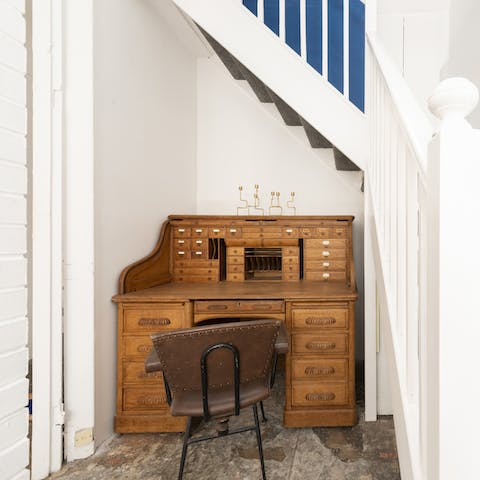 Catch up on emails from this quiet nook complete with an Edwardian antique desk
