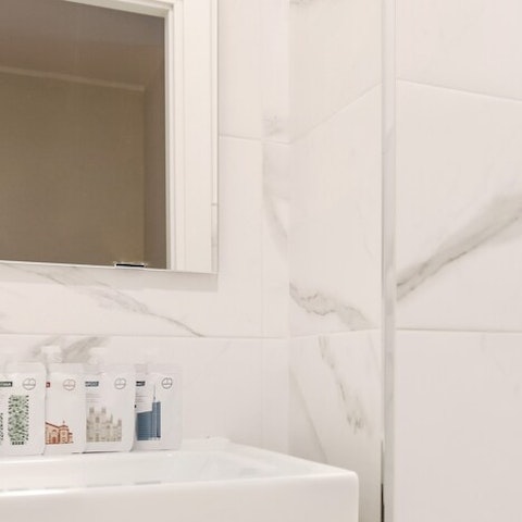 Enjoy getting ready in a modern marble-clad bathroom