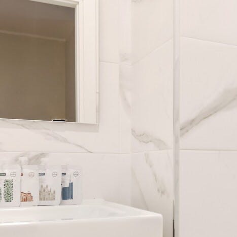 Enjoy getting ready in a modern marble-clad bathroom