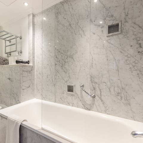 Treat yourself to a relaxing bubble bath in the marble tub