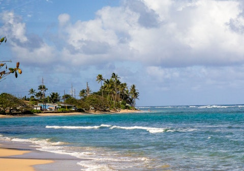 Bask in the sunshine on Poipu Beach, a seven-minute drive away