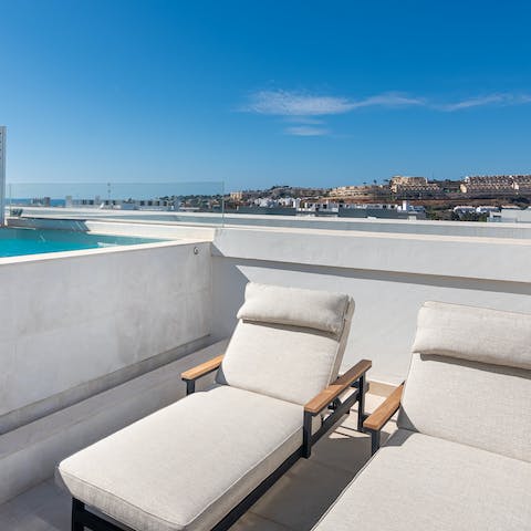 Lounge overlooking the architecture of La Cala de Mijas from the rooftop terrace