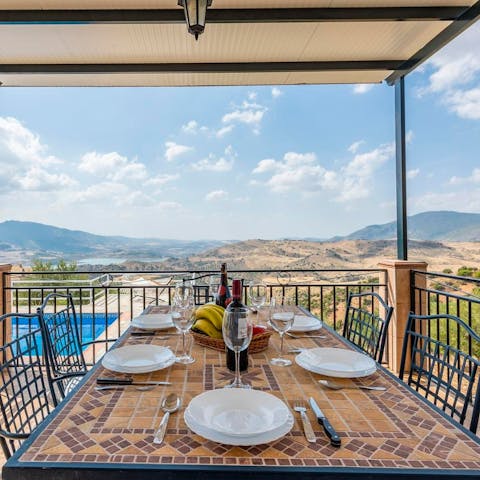 Share plates of paella and bottles of Rioja wine on the outdoor dining table