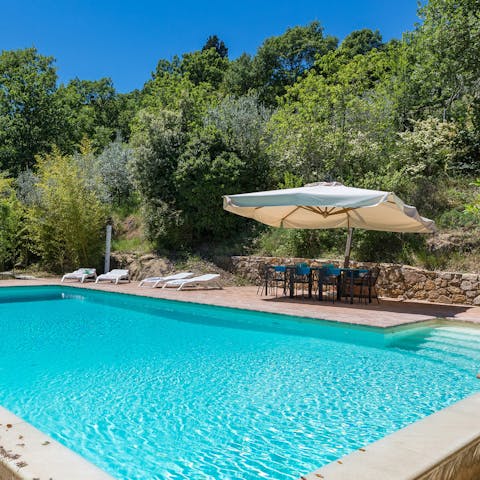 Take a dip in the glistening infinity pool with serene downhill views