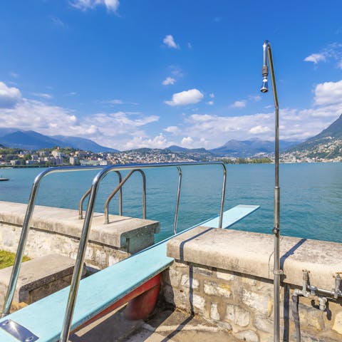 Jump into Lake Lugano from the diving board just across the street from your home