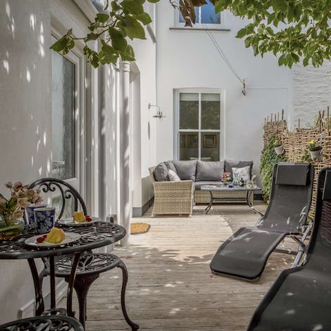 Open up the French doors leading out onto the suntrap decking and garden