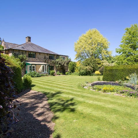 Explore the manicured grounds and woodland walkways around you