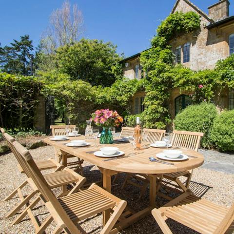 Dine amidst the pretty foliage at the teak outdoor table