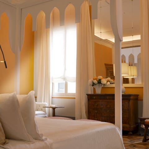 Sink into the bespoke, canopied bed