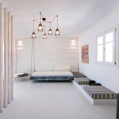 Unwind on the day beds after a day of exploring Mykonos Town – 10km away