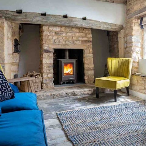 Cosy up with a glass of wine in front of the log burner
