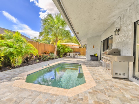 Cool off in the pool surrounded by tropical palms