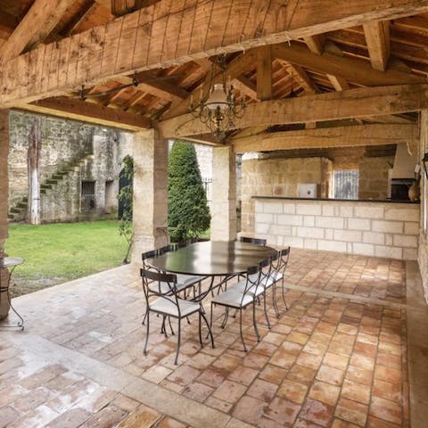 Enjoy alfresco meals paired with local French wine under the pergola