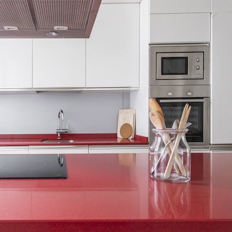 Flex your culinary muscles in the shiny kitchen, complete with bright red countertops