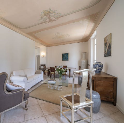 Relax in the living room and admire the painted ceiling and oversized ceramic vases