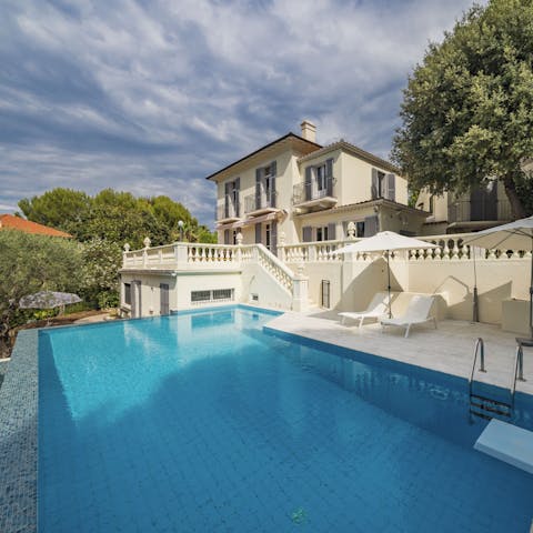 Spend long days poolside, cocktail and book in hand