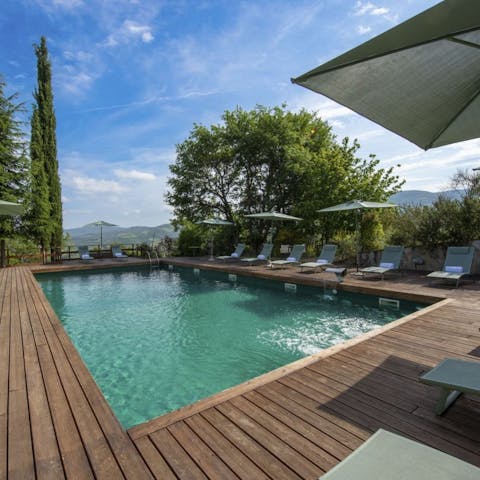 Stretch out poolside with sweeping views across the surrounding hills