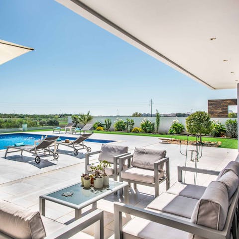 Sip happy hour cocktails at every hour from the covered terrace lounge