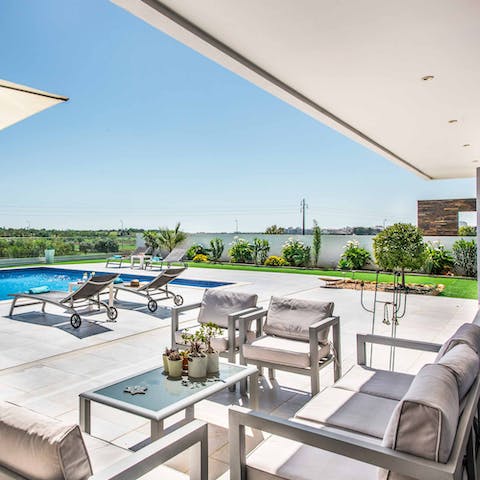 Sip happy hour cocktails at every hour from the covered terrace lounge