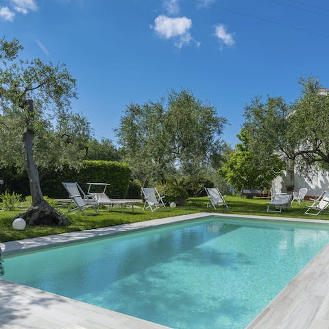 Lounge by the pool under the hot, Italian sun