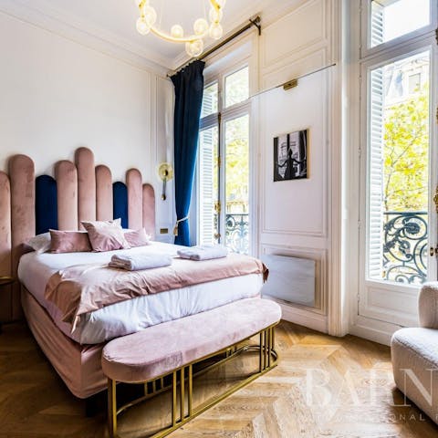 Wake to sunlight streaming in through the traditional Parisian windows