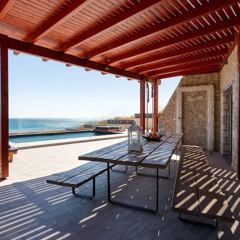Gather in the shade of the terrace to dine alfresco or enjoy drinks in the evening by the pool