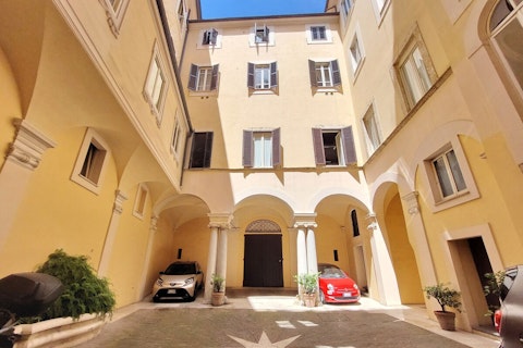 Arrive through a centuries-old Roman courtyard with vaulted arcades