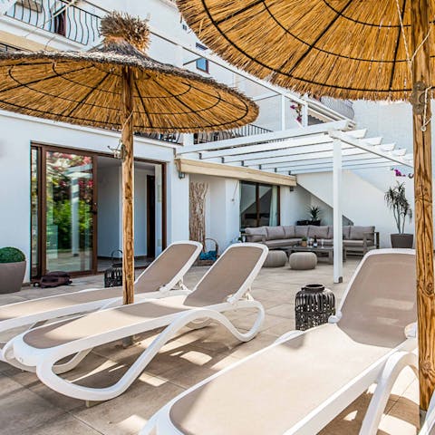 Settle on a sun lounger for some rest in the shade
