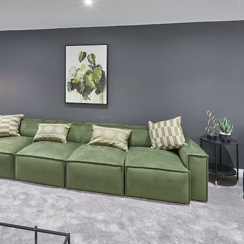 Open a bottle of your favourite wine and unwind on the comfy green sofa