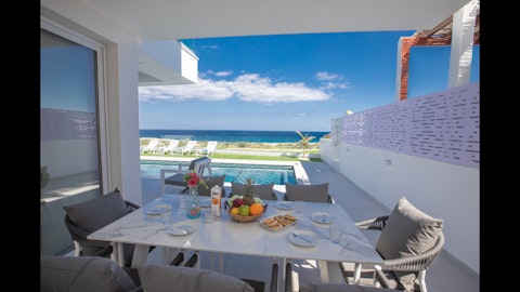 Dine beside the pool beneath wide-open skies and sea