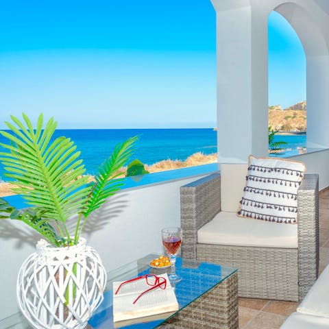 Relax with a glass of raki as you take in the sea views
