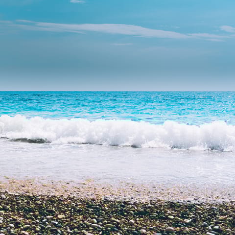 Sink your feet into the sea at Gialo Skala beach, a five-minute drive away