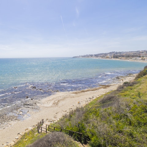 Embrace the laid-back pace of coastal living from the nearby beach