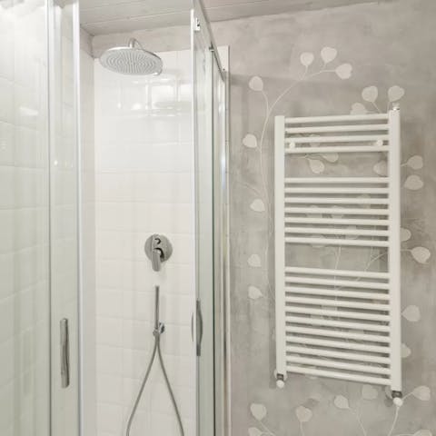 Relax and unwind beneath the bathroom's rainfall shower