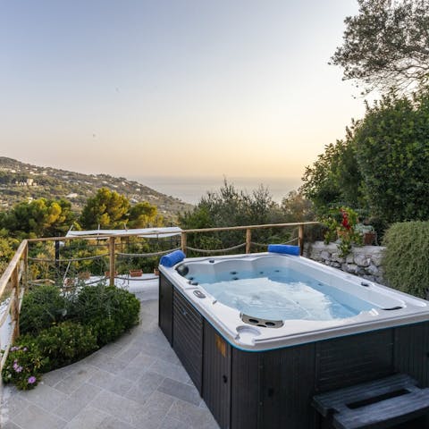 Unwind in the jacuzzi as the sun sets around you