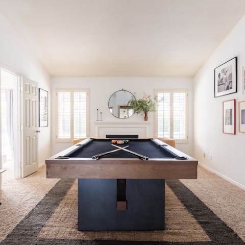 Play a game of pool in the living room