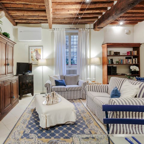 Sink into the sumptuous striped sofa and rest weary legs after a long day exploring