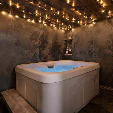 Soak your cares away in the hot tub beneath twinkling fairy lights