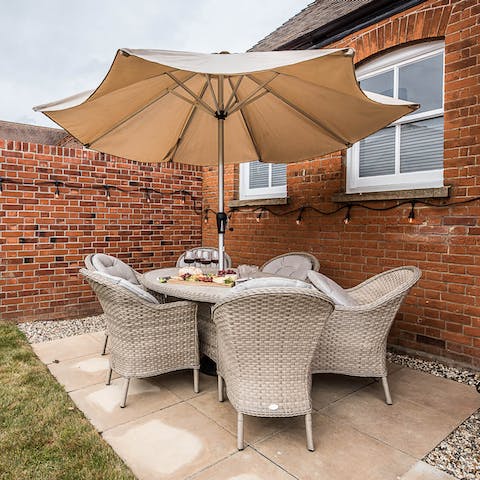 Sit outside on the patio in the garden on balmy summer evenings