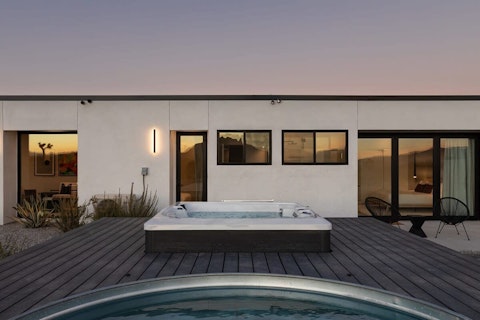 Unwind in the hot tub as the desert sky fades to dark