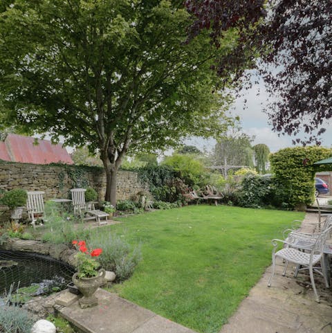 Relax in the Gloucestershire sun by the pond in the shared garden