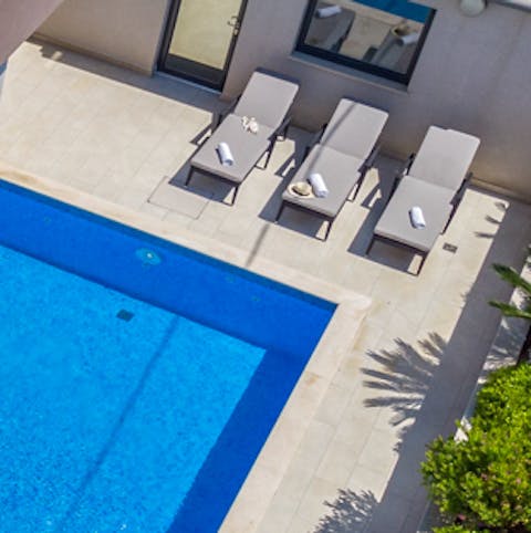 Catch some sun relaxing by your private pool