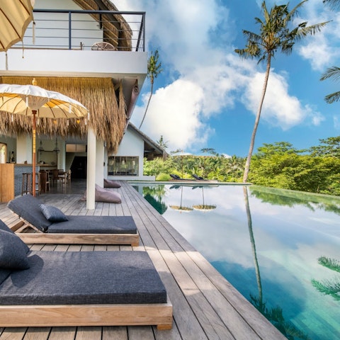 Relax by the private pool, surrounded by jungle