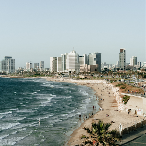 Take a breezy stroll down to Aviv Beach and dip your toes into the waves