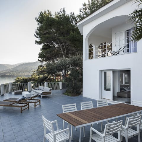 Gather the family for a traditional Sicilian meal at the large outdoor table