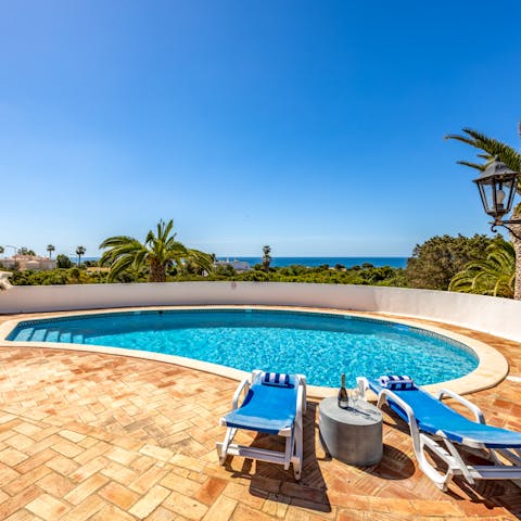 Put your feet up beneath blue skies and pamper yourself with poolside cocktails